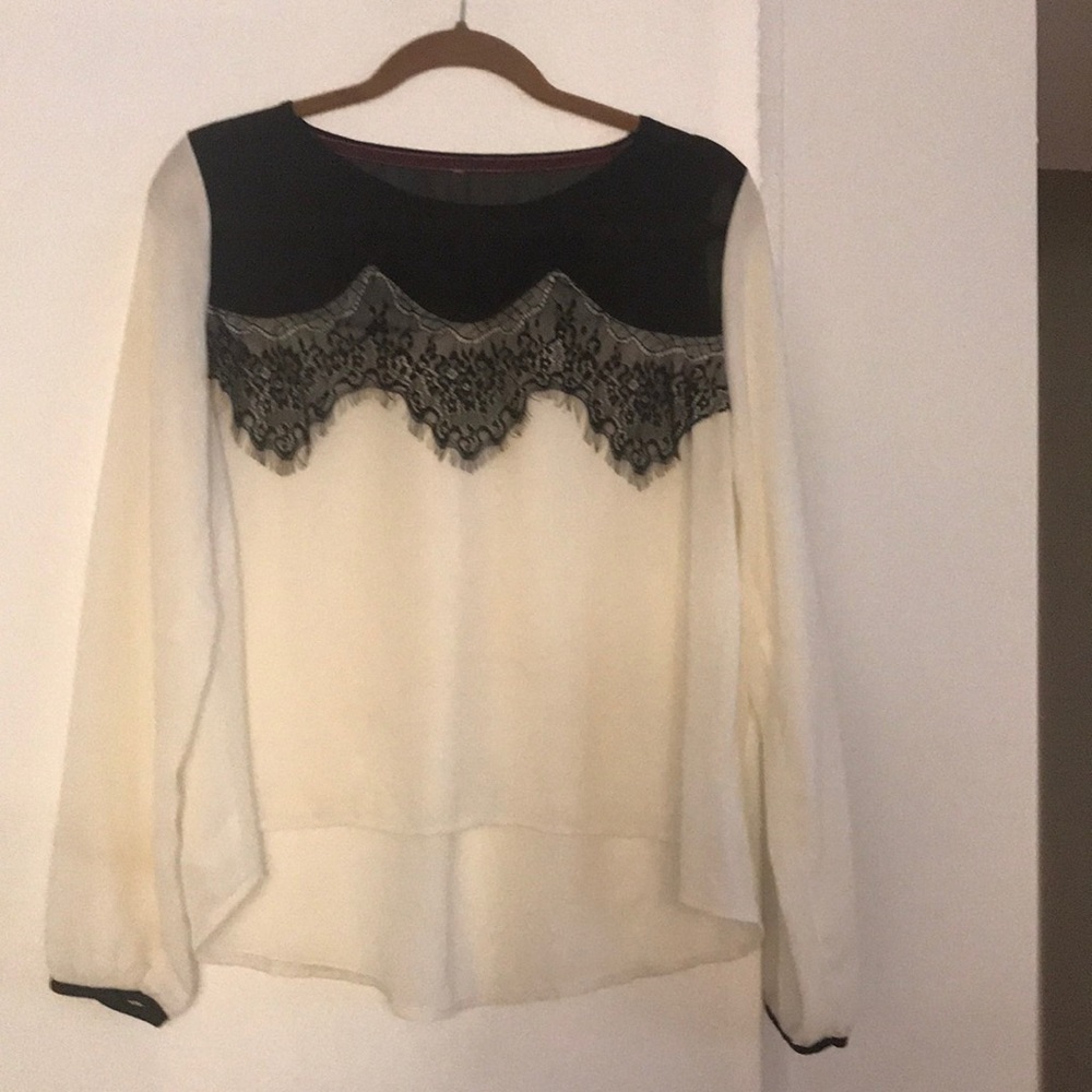 Cream colored blouse w/ black lace